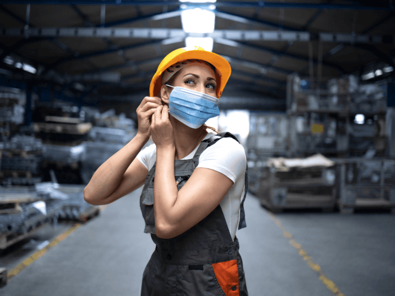 Industrial worker with face mask and hard hat